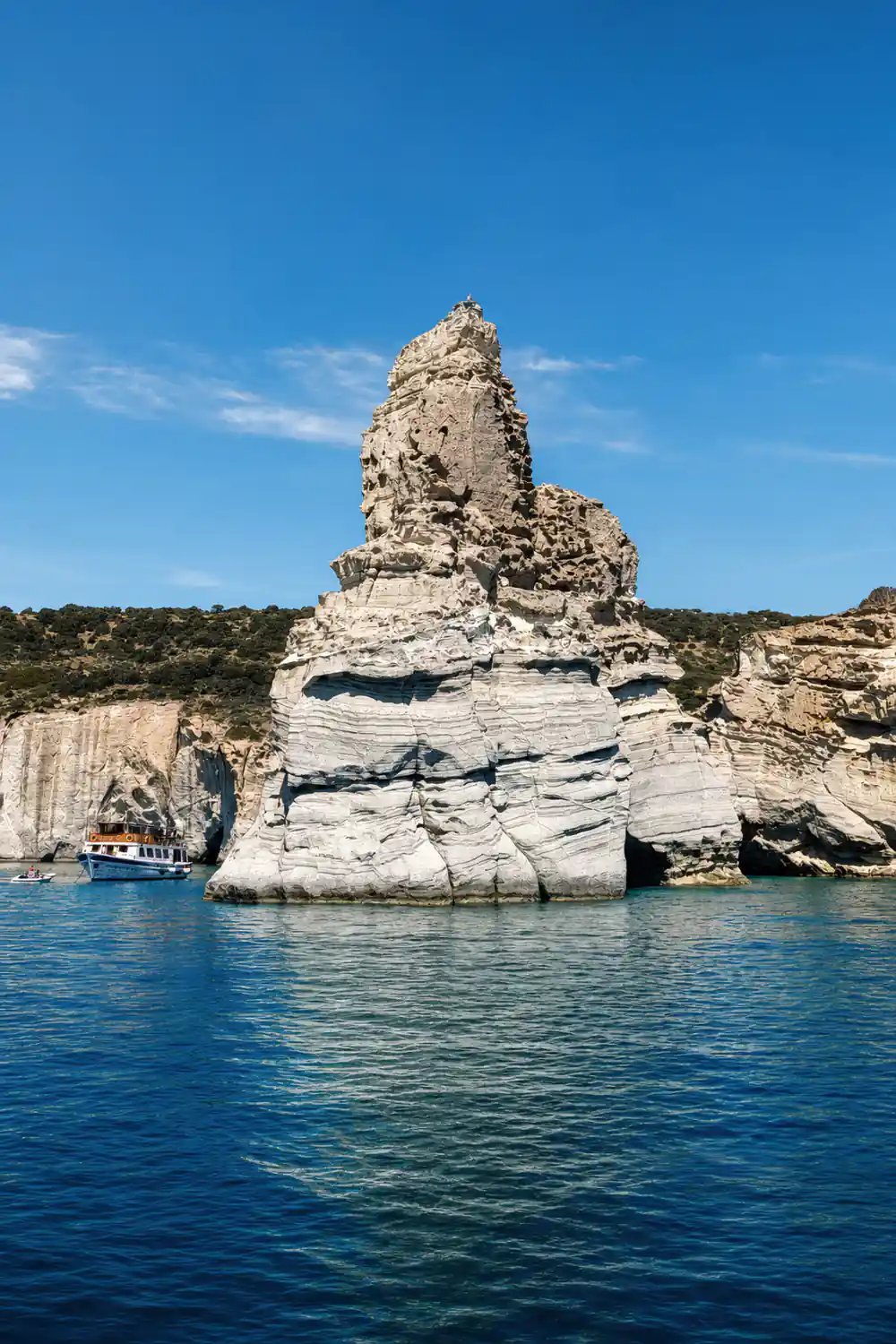 Eroded rock tower standing on a low headland