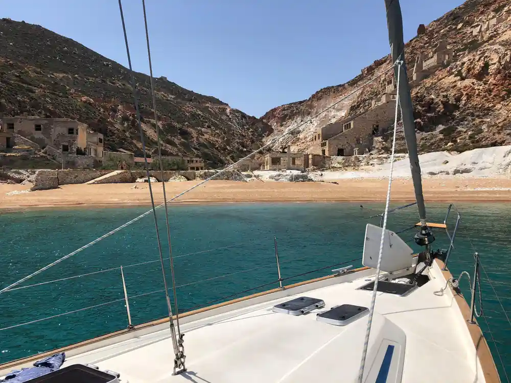 Foredeck view of a beach with old industrial buildings