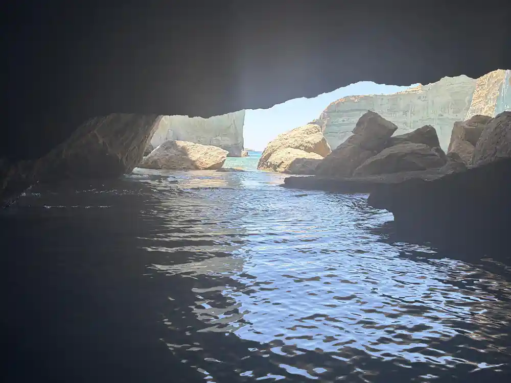 Looking out of a sea cave to bright water beyond