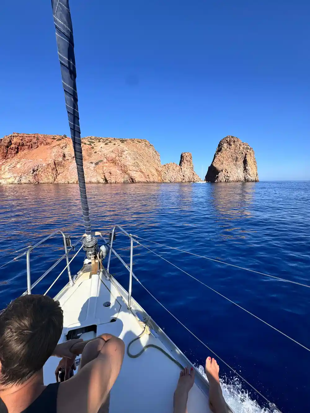 Passenger on the bow watching red rock stacks ahead