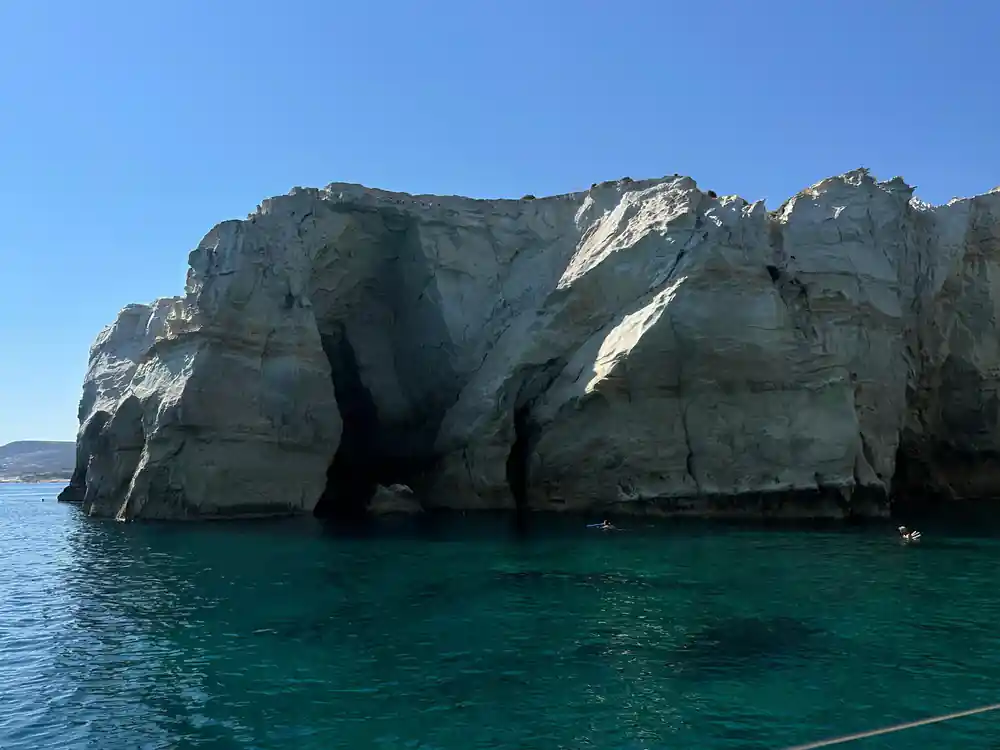 Rounded white rock formation with caves at its base