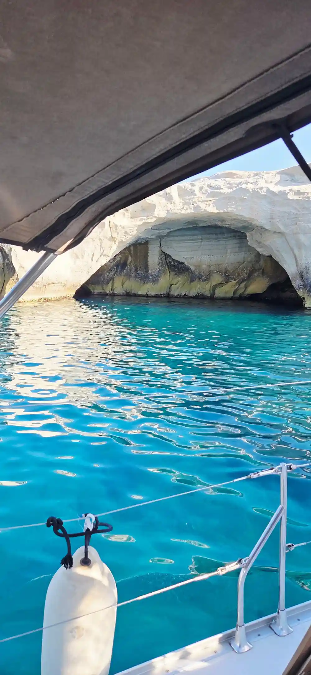Sea cave arch seen from beneath the boat's canopy