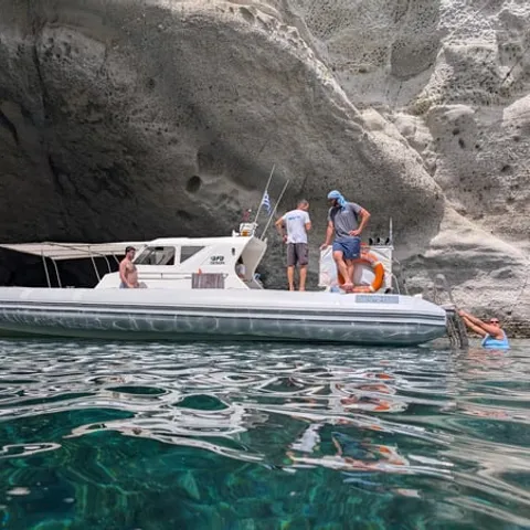 A speedboat moored in clear water off Milos