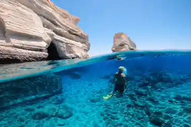 Split shot of a snorkeller in clear water by the stacks