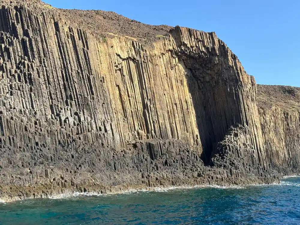 Tall basalt columns rising sheer from the sea