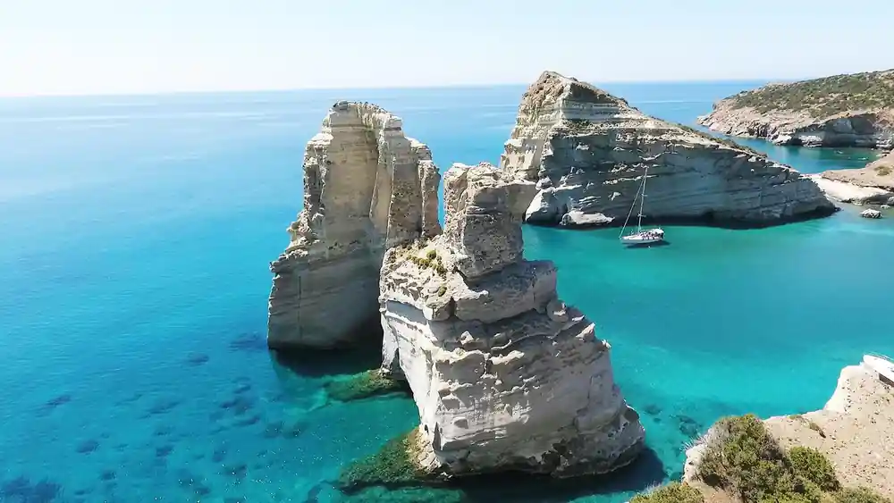 White rock stacks and arches standing in a clear bay