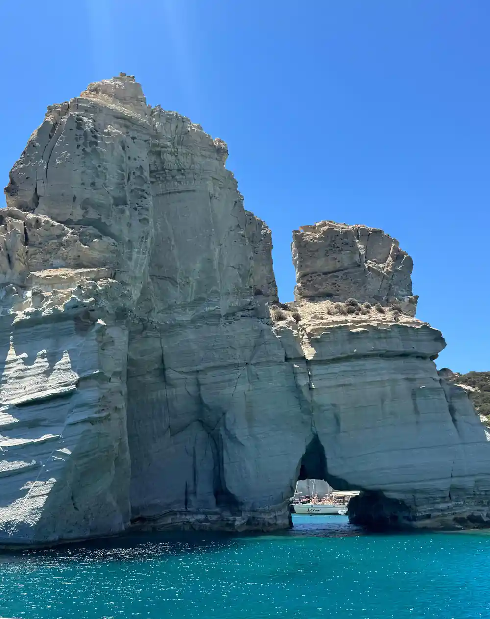 White rock towers standing above a small boat